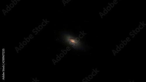 Faint diffuse galaxy in deep black space with sparse stars, astronomy and cosmos concept