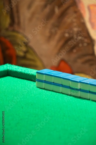 Mahjong Tiles on Green Felt