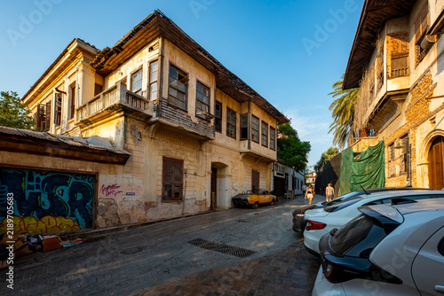 Antalya, Turkey - August 27, 2026: The image shows a historic cobblestone street in Kaleiçi, the old town of Antalya, Türkiye, featuring traditional Ottoman-style architecture and ancient stone. Histo