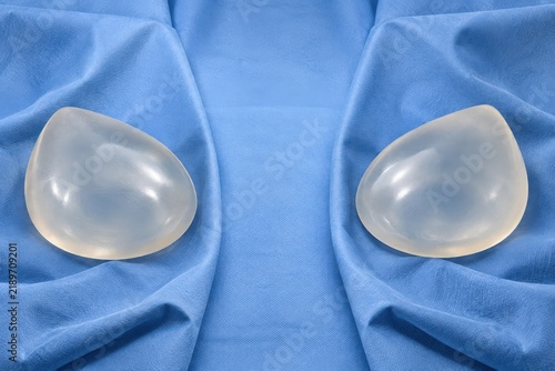 Pair of silicone breast implants on sterile blue drape