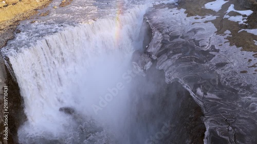 Aerial view of waterfall Dettifoss shrouded in fog and rugged terrain
