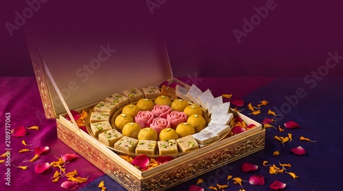 A beautifully decorated gift box filled with traditional indian sweets for the festive celebration of diwali in india