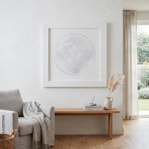 Subtle circular abstract artwork above a wooden console in a serene interior