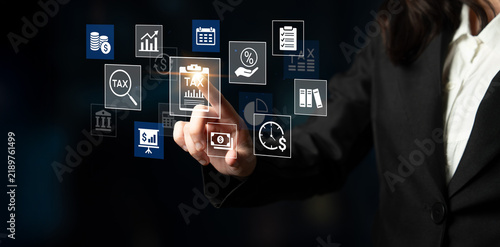 Foto Businesswoman Interacting with Financial Icons on a Digital Screen Representing Taxation, Analytics, Planning, and Management in a Modern Office Environment