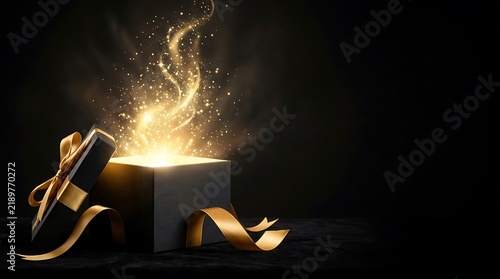 A magical luxury open gift box glowing with golden light and sparkling particles isolated on a dark background for festive holiday celebration concepts