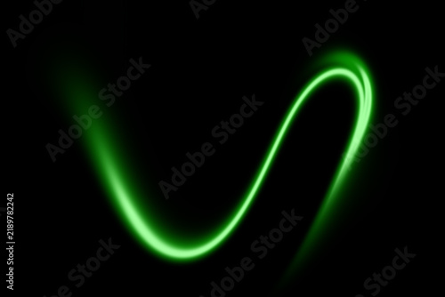Konstfotografi Abstract glowing green light trail on black background