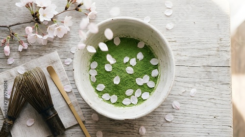 Cherry Blossoms Falling Into A Traditional Matcha Green Tea Bowl Arrangement