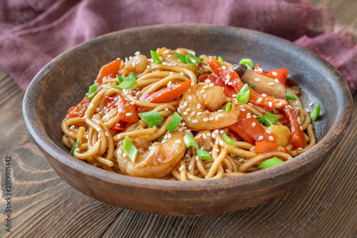 Naklejka Close up Asian udon noodles with shrimp mushrooms sesame glossy savory stir fry