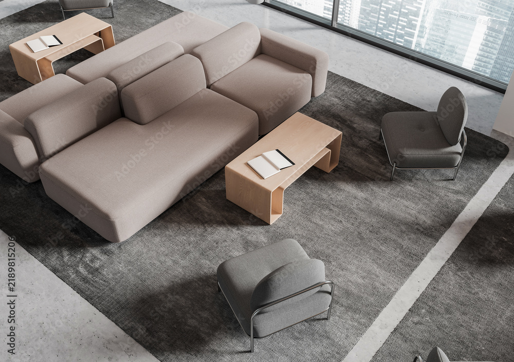 Obraz premium Modern living room interior with modular sofas, lounge chairs, wood tables, and city windows in a realistic style on a neutral rug, 3D Rendering
