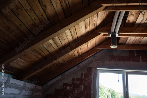 фотографія Timber roof construction seen from inside the attic of a new house