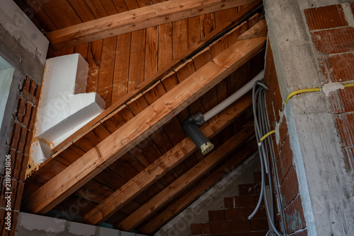 Quadro su tela Timber roof construction seen from inside the attic of a new house