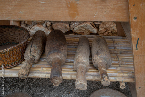 Принти на полотні Traditional wooden mallets resting on a bamboo shelf for grape crushing in Spain