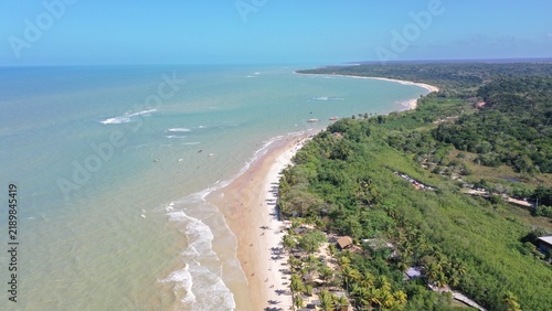 Fantastic aerial view of Nativos Beach with white sand, coconut trees and tropical nature in Trancoso, Bahia, Brazil