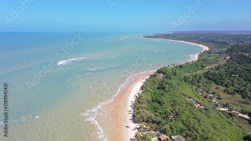 Fantastic aerial view of Nativos Beach with white sand, coconut trees and tropical nature in Trancoso, Bahia, Brazil