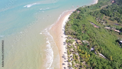 Fantastic aerial view of Nativos Beach with white sand, coconut trees and tropical nature in Trancoso, Bahia, Brazil
