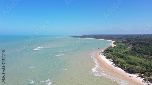 Fantastic aerial view of Nativos Beach with white sand, coconut trees and tropical nature in Trancoso, Bahia, Brazil