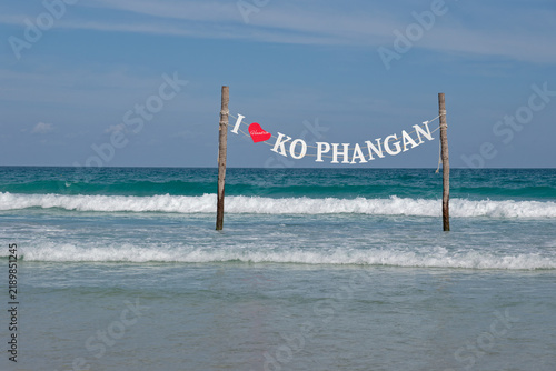 I Love Ko Phangan sign banner installed in the turquoise sea water on a tropical beach in Thailand
