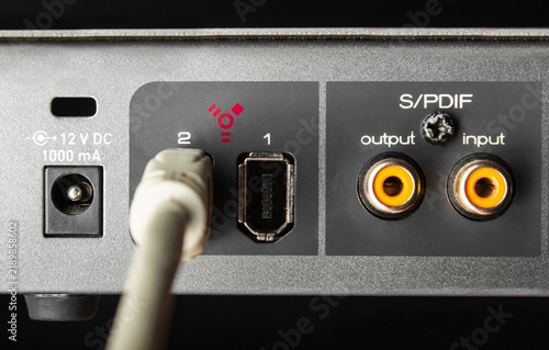 Принти на полотні Photo of a firewire sound board input connector sockets on black background