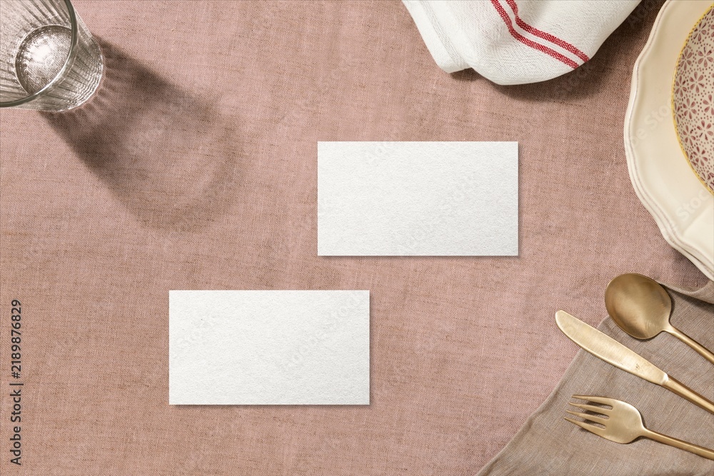 Naklejka premium Blank cards on rustic table setting with plates and cutlery