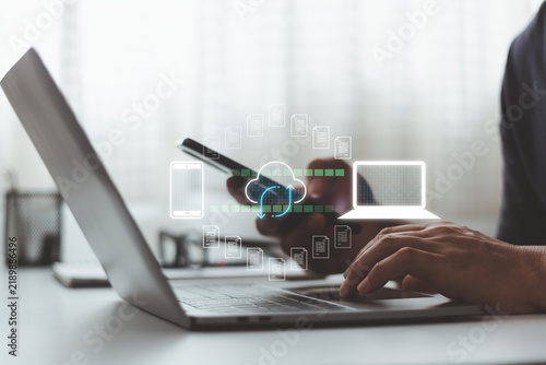 Cloud sync technology concept. Person use smartphone and laptop for data synchronization notification system secure file transfer communication integration and real time digital connection workflow.