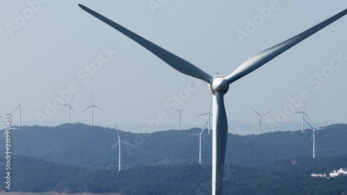 Wind turbines on rolling green hills generating clean energy