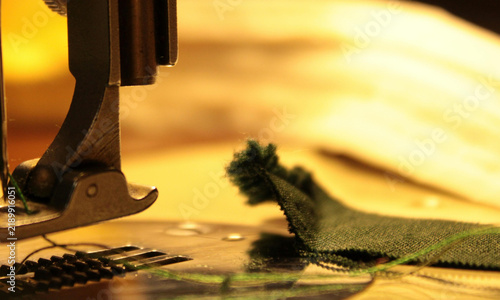 Foto Close-up view of a professional sewing machine needle working on green fabric cr