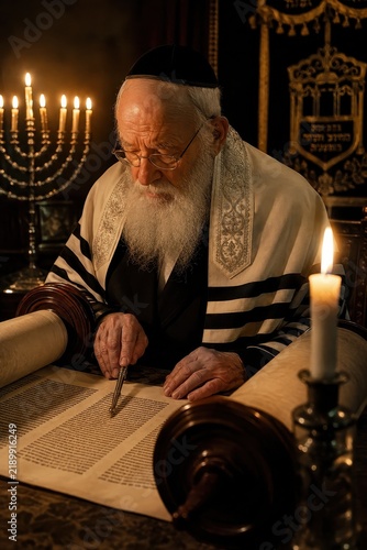 Elderly Rabbi Reading Torah Scroll By Candlelight