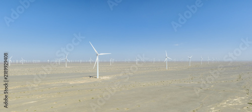 Vast Wind Farm Turbine Array Across Gobi Desert Landscape