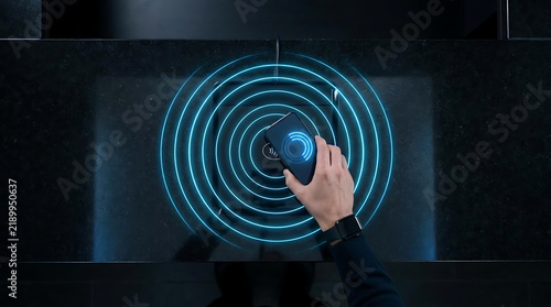 Cutting edge wireless charging technology featuring a hand placing a smartphone on a sleek surface with a visual depiction of energy transfer in circular patterns