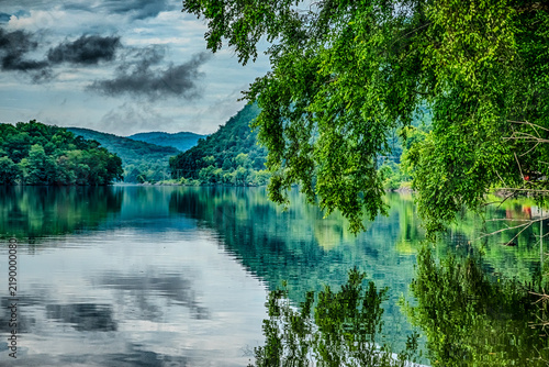 Calm lake water reflecting trees and clouds near the Tail of the Dragon North Carolina