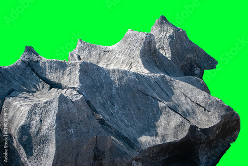 Fotografía Unique karst rock formation, rough texture, and blackish-gray surface color set against a green background—suitable as a 3D digital imaging asset