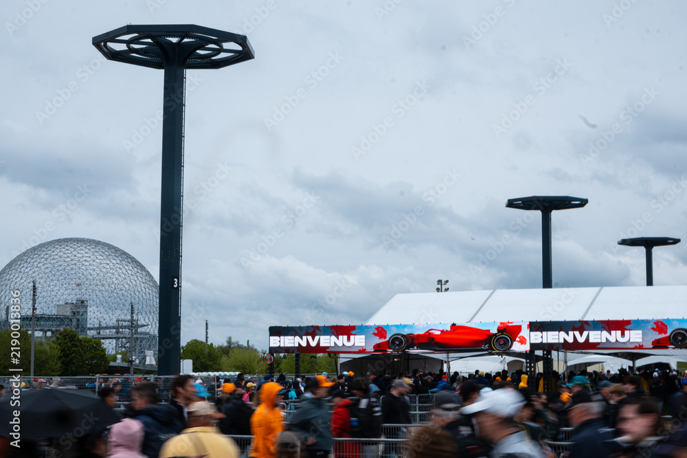 Obraz premium May 24, 2026, Montreal, Canada, F1 fans walk near the Canadian Grand Prix entrance at Parc Jean-Drapeau. g.