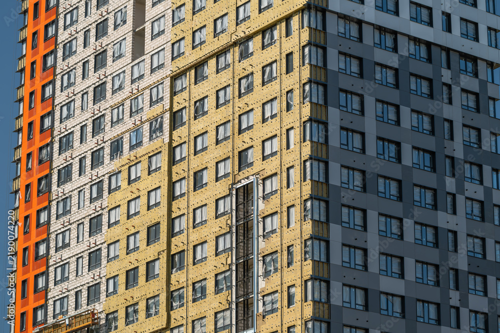 Fototapeta premium Modern architectural marvel showcasing vibrant colors and unique design elements in a lively urban area during the bright afternoon