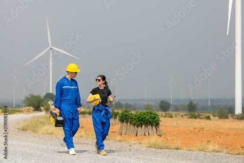 фотографія Team technician discussing wind turbine power generator sustainability performan