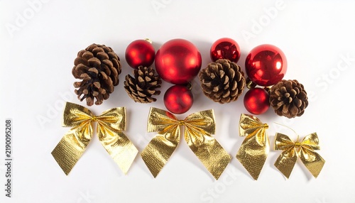 Christmas pinecones with red ornaments and gold bows.
