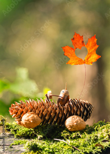 Handmade Autumn car from pine cone in the Sunlit Forest in fall season