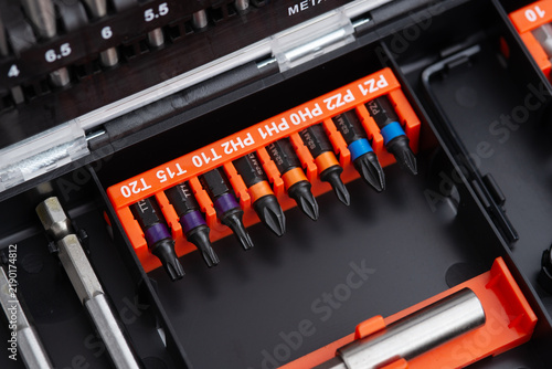 Fotografie Close up of screwdriver bits and magnetic bit holder neatly organized in a professional tool case
