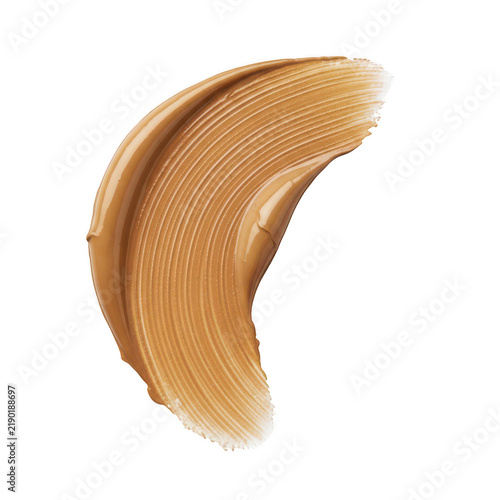 A single curved stroke of brown liquid cosmetic foundation makeup swatch isolated on a simple plain surface