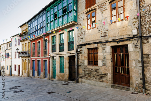Bild auf Leinwand Colorful Historic Townhouses with Balconies and Bunting, Lugo, S