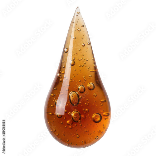 Single brown liquid drop with small bubbles inside representing a splash of honey or maple syrup ingredient