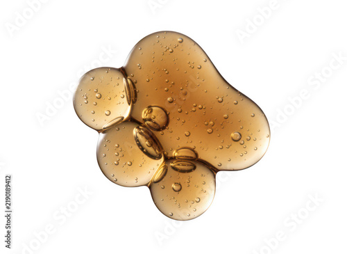 A thick drop of golden cosmetic oil or serum gel with small bubbles for skincare beauty product promotion