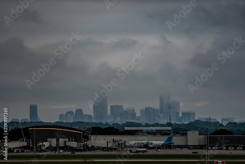 Charlotte skyline beyond airport terminal under overcast sky