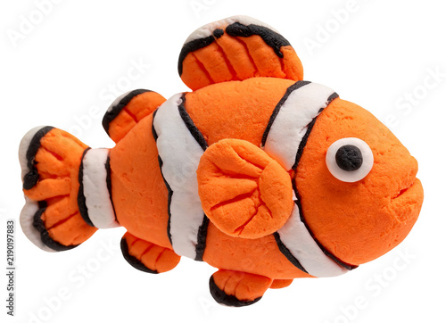 Handmade clay clownfish with orange and white stripes on a white background