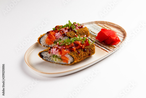 Konstfotografi Fried salmon sushi rolls with pickled ginger on ceramic plate food