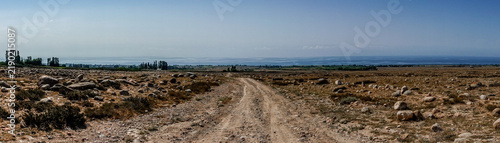 Rough dirt road through rocky terrain and mountains Kyrgyzstan