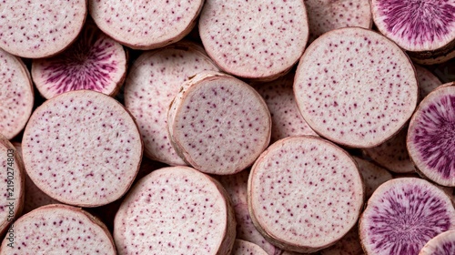 Close-up view of sliced purple taro root with distinctive pinkish-purple speckles