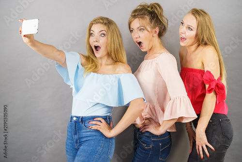 Fashionable women taking selfie