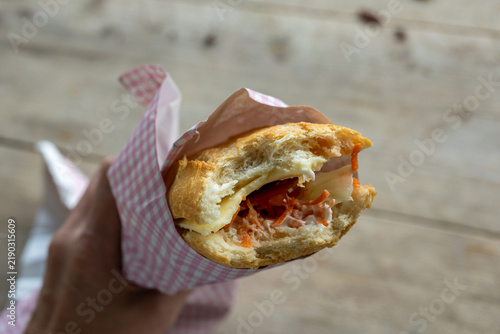 Hand Holding Cheese Sandwich with Carrot and Sauce, Belgium