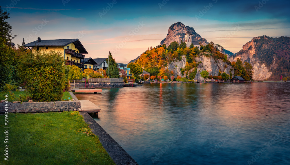Fototapeta premium Calm evening scene of Johannesbergkapelle church on the edge of cliff. Stunning autumn sunset on Traunsee lake. Colorful landscape of Austrian Alps with Traunstein peak on background, Austria, Europe.