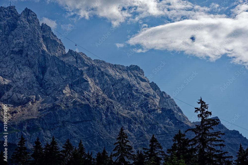 Obraz premium Cable Car Tower and Majestic Face of Mount Zugspitze in Bavaria Germany